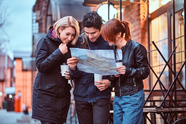 group tourists searching place map near cafe outside 613910 19690